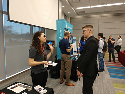 Alexi McCallick of Tooling and Tester Design at Pantex (left) talks with a student at the Texas A&M Nuclear Security Enterprise Day