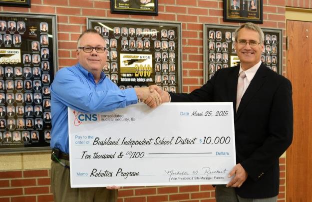 Joe Papp, CNS Director of Mission Engineering, presents the 0,000 donation to Don Wood, Bushland ISD Superintendent, to kick off the district's robotics program.