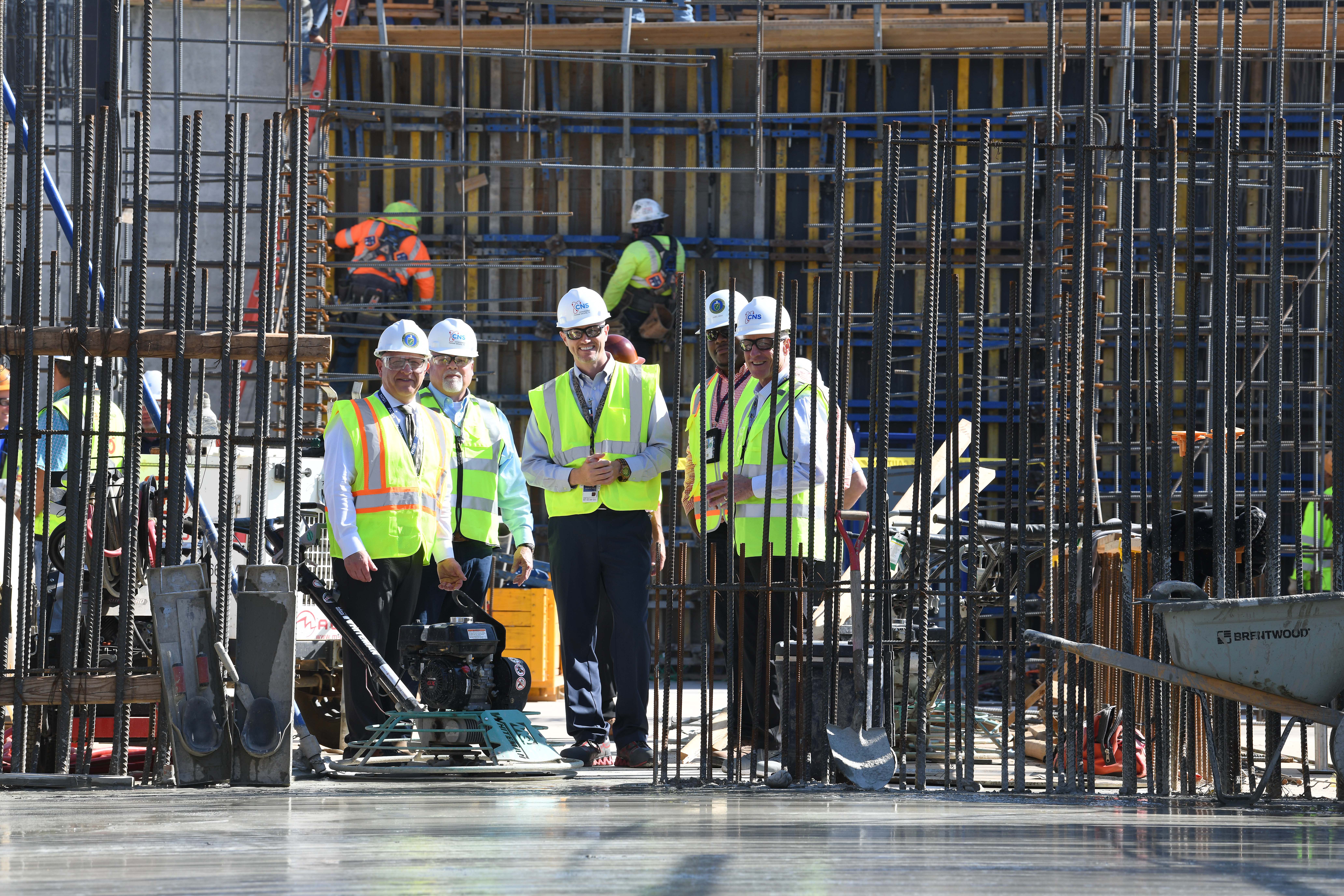 CNS and NPO leadership look on as the final 250 cubic yards of concrete are placed to complete the High Explosive lab foundation.