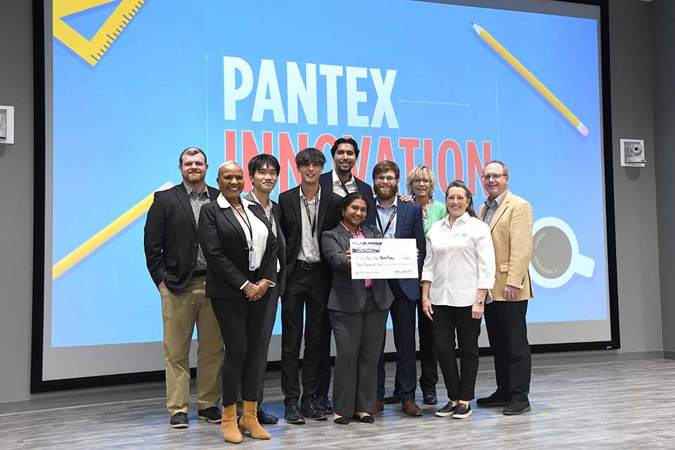 Students from the third-place team with the competition's judges and hosts. 