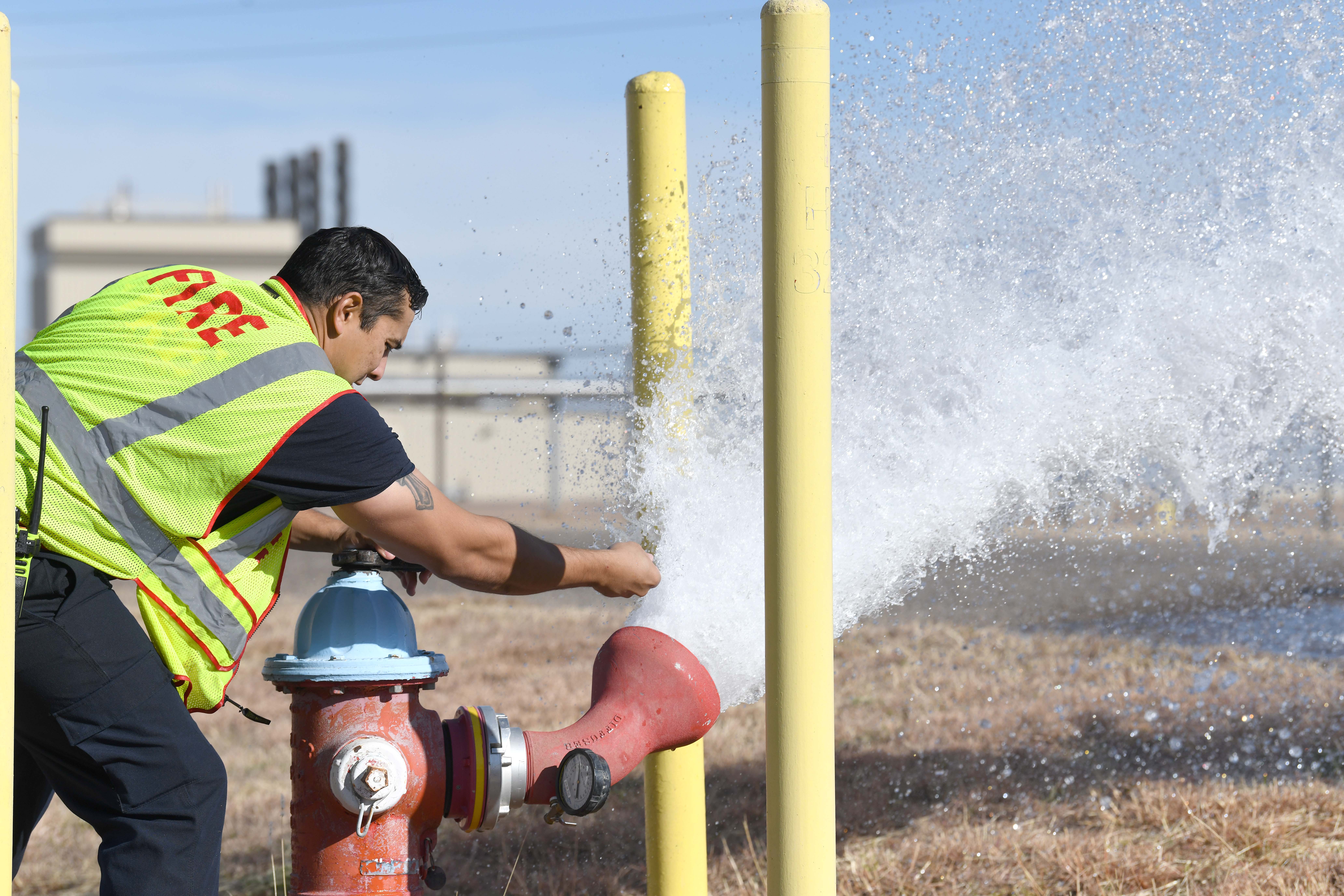 Firefighters test hydrants annually to verify operational conditions and document flow rate. 