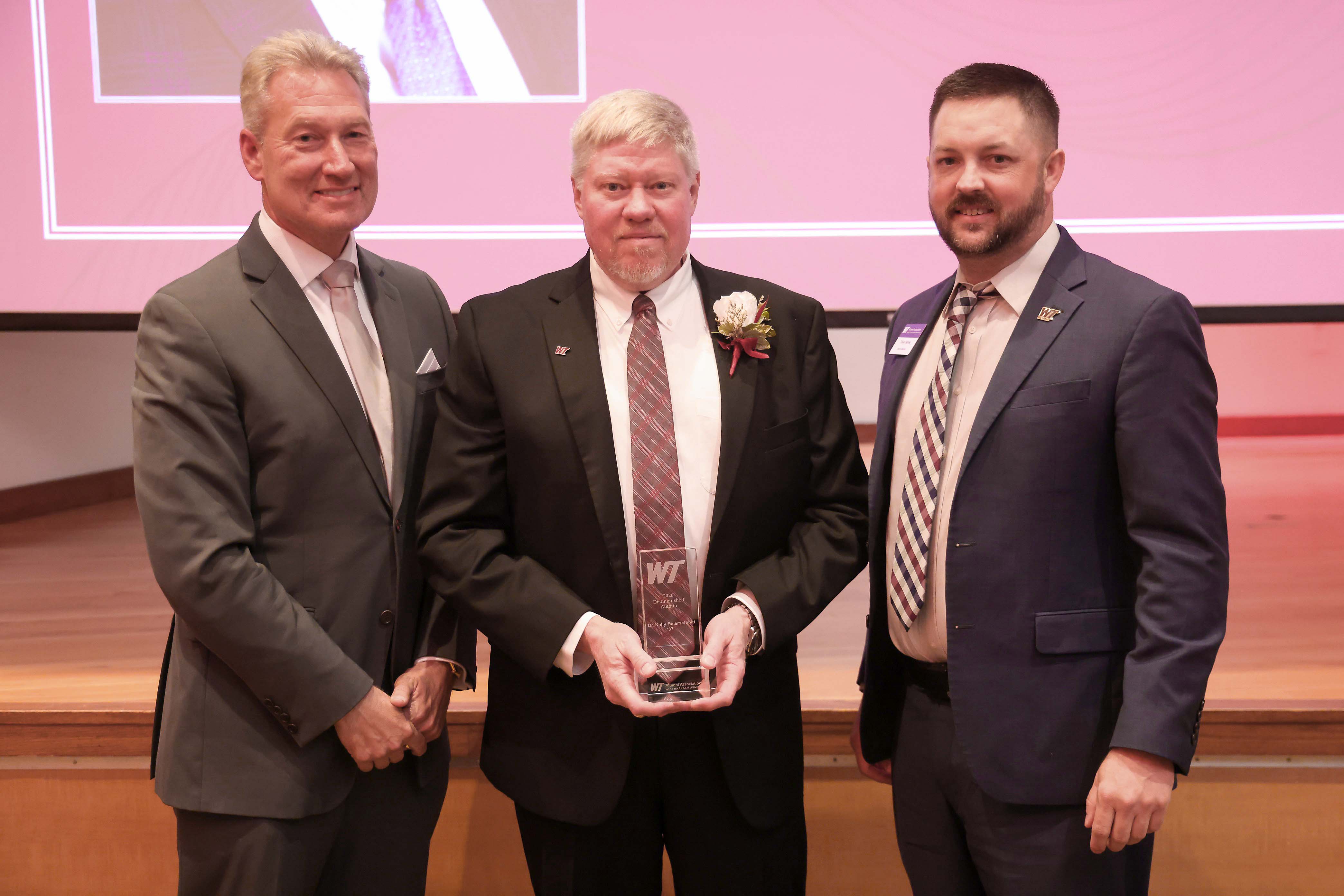 PXD President and General Manager Kelly Beierschmitt (center) receiving the 2026 WT Distinguished Alumni Award with WT Interim President Neil Terry (left) and WT Alumni Association Board President Trevor Barnes (right). Photo provided by West Texas A&M University. 