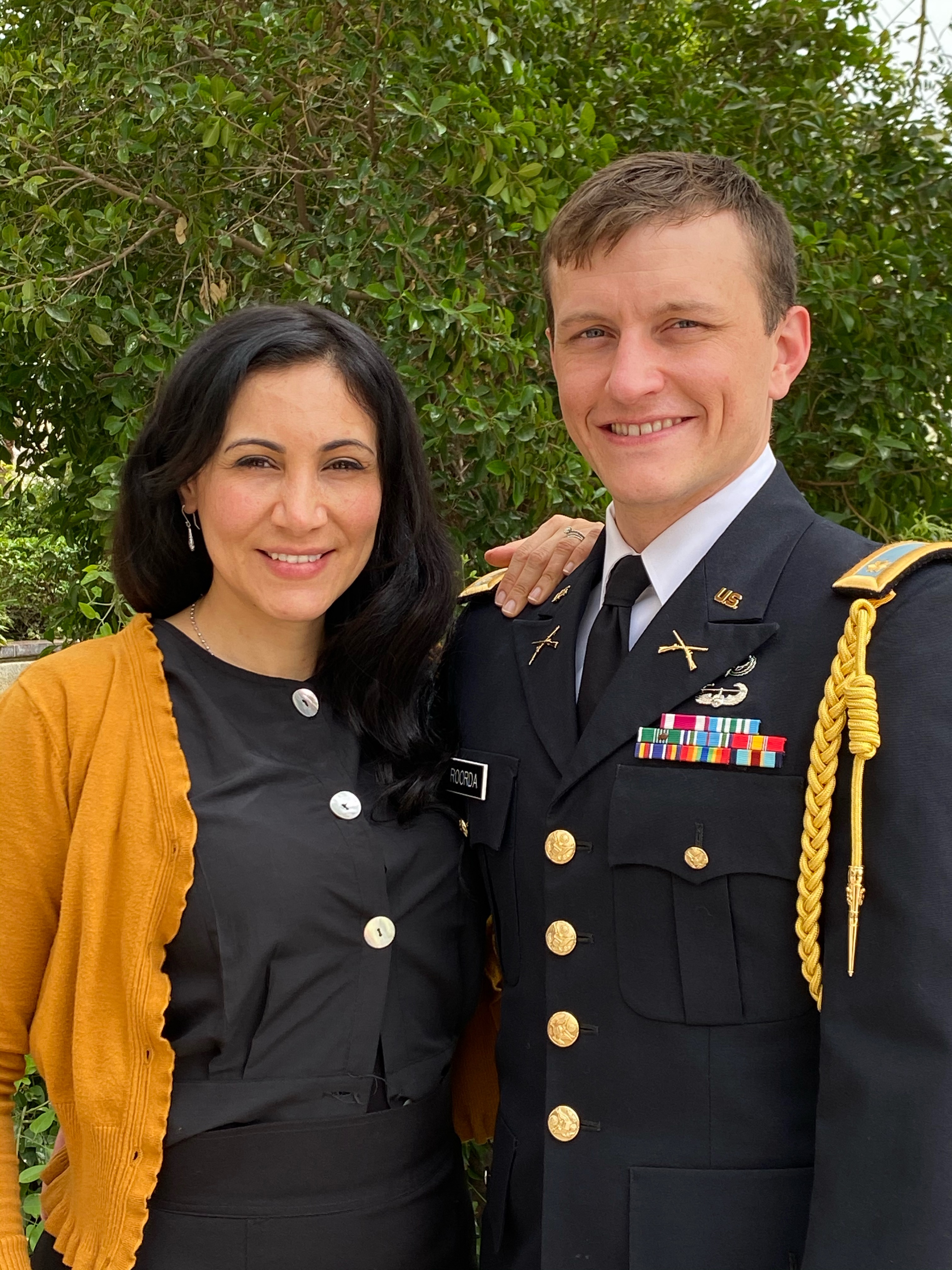 Rose R. stands with her husband, Major Brennan R., at his promotion ceremony.