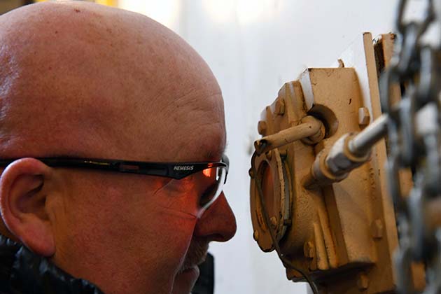 Deputy Site Manager Kenny Steward examines the sight glass, which give him a look inside one of the Pantex boilers.