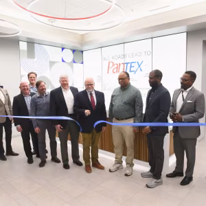 Dignitaries cutting a ribbon to open HESE